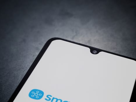 Lod, Israel - July 16,2023: Smartthings app launch screen on smartphone on dark marble stone background. Top view flat lay with copy space.
