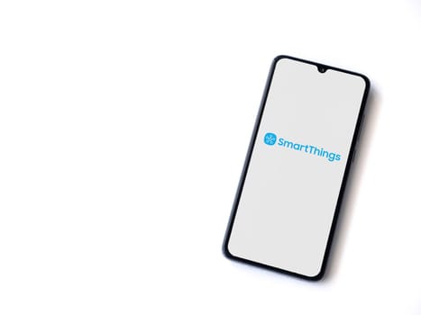 Lod, Israel - July 16,2023: Smartthings app launch screen on smartphone on white background. Top view flat lay with copy space.