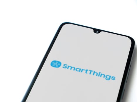 Lod, Israel - July 16,2023: Smartthings app launch screen on smartphone on white background. Top view flat lay with copy space.