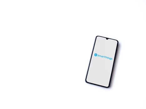 Lod, Israel - July 16,2023: Smartthings app launch screen on smartphone on white background. Top view flat lay with copy space.