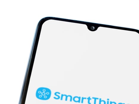 Lod, Israel - July 16,2023: Smartthings app launch screen on smartphone on white background. Top view flat lay with copy space.
