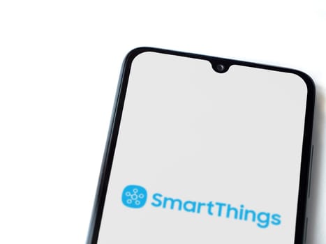 Lod, Israel - July 16,2023: Smartthings app launch screen on smartphone on white background. Top view flat lay with copy space.