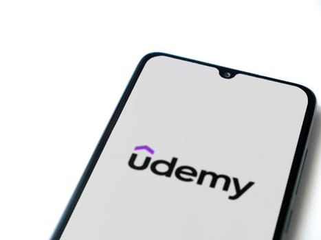 Lod, Israel - July 16,2023: Udemy app launch screen on smartphone on white background. Top view flat lay with copy space.