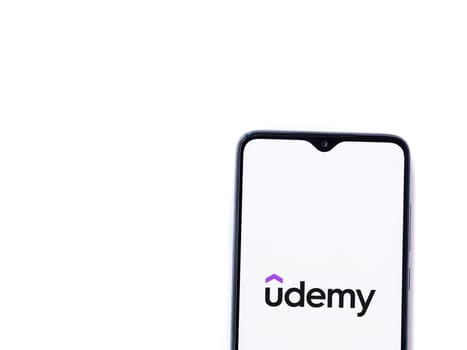 Lod, Israel - July 16,2023: Udemy app launch screen on smartphone on white background. Top view flat lay with copy space.