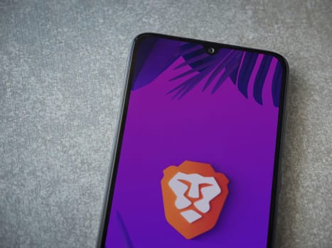 Lod, Israel - July 16,2023: Brave Private Browser app launch screen on smartphone on ceramic stone background. Top view flat lay with copy space.