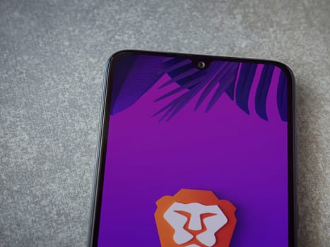 Lod, Israel - July 16,2023: Brave Private Browser app launch screen on smartphone on ceramic stone background. Top view flat lay with copy space.