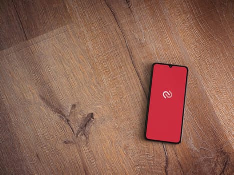 Lod, Israel - July 16,2023: Twilio Authy Authenticator app launch screen on smartphone on wooden background. Top view flat lay with copy space.