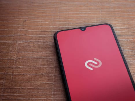 Lod, Israel - July 16,2023: Twilio Authy Authenticator app launch screen on smartphone on wooden background. Top view flat lay with copy space.