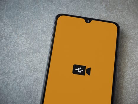 Lod, Israel - July 16,2023: USB Camera app launch screen on smartphone on ceramic stone background. Top view flat lay with copy space.