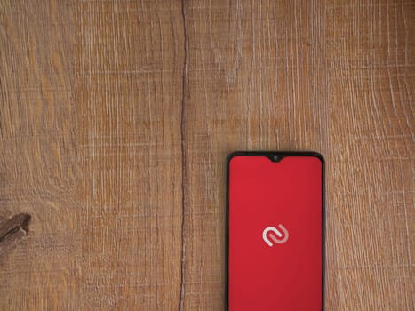 Lod, Israel - July 16,2023: Twilio Authy Authenticator app launch screen on smartphone on wooden background. Top view flat lay with copy space.