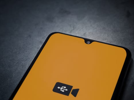 Lod, Israel - July 16,2023: USB Camera app launch screen on smartphone on dark marble stone background. Top view flat lay with copy space.
