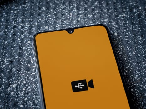Lod, Israel - July 16,2023: USB Camera app launch screen on smartphone on metallic background. Close up top view flat lay.