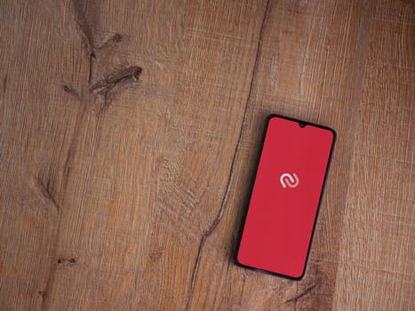 Lod, Israel - July 16,2023: Twilio Authy Authenticator app launch screen on smartphone on wooden background. Top view flat lay with copy space.