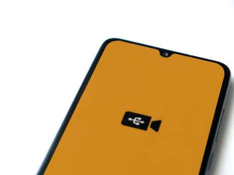 Lod, Israel - July 16,2023: USB Camera app launch screen on smartphone on white background. Top view flat lay with copy space.