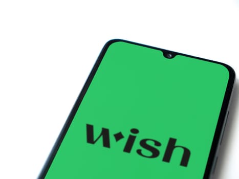 Lod, Israel - July 16,2023: Wish app launch screen on smartphone on white background. Top view flat lay with copy space.