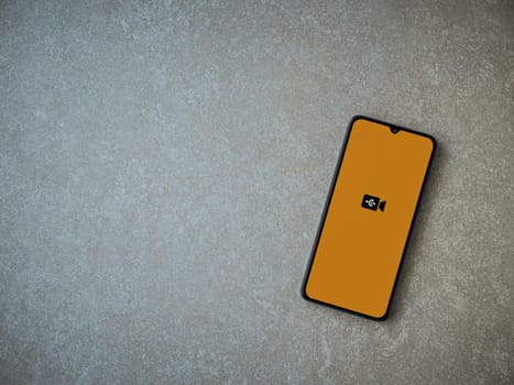 Lod, Israel - July 16,2023: USB Camera app launch screen on smartphone on ceramic stone background. Top view flat lay with copy space.