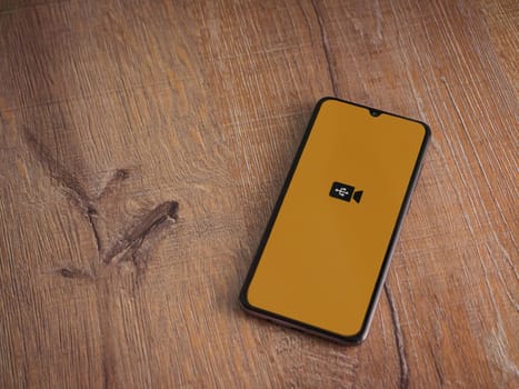 Lod, Israel - July 16,2023: USB Camera app launch screen on smartphone on wooden background. Top view flat lay with copy space.