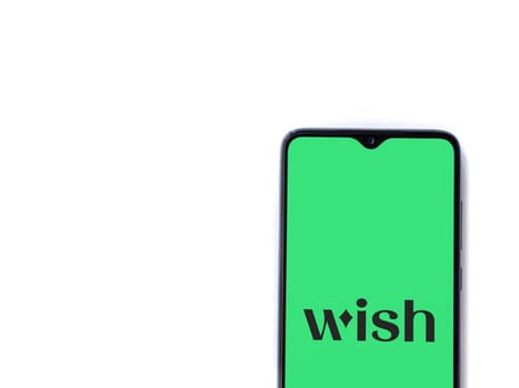 Lod, Israel - July 16,2023: Wish app launch screen on smartphone on white background. Top view flat lay with copy space.