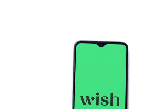 Lod, Israel - July 16,2023: Wish app launch screen on smartphone on white background. Top view flat lay with copy space.