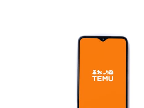 Lod, Israel - July 16,2023: Temu app launch screen on smartphone on white background. Top view flat lay with copy space.