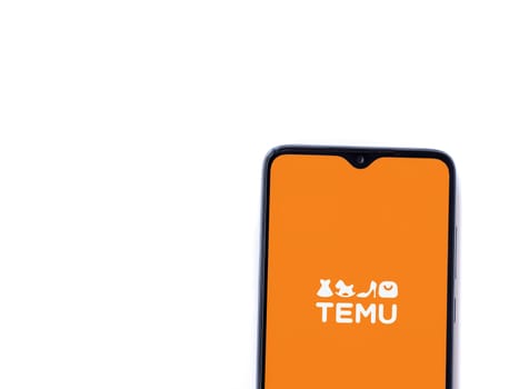 Lod, Israel - July 16,2023: Temu app launch screen on smartphone on white background. Top view flat lay with copy space.