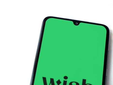 Lod, Israel - July 16,2023: Wish app launch screen on smartphone on white background. Top view flat lay with copy space.