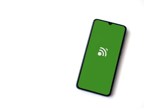 Lod, Israel - July 16,2023: Unified Remote app launch screen on smartphone on white background. Top view flat lay with copy space.