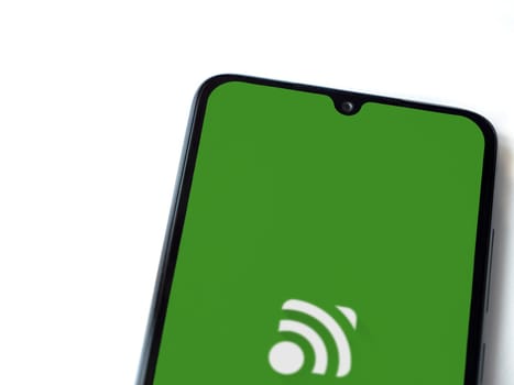 Lod, Israel - July 16,2023: Unified Remote app launch screen on smartphone on white background. Top view flat lay with copy space.