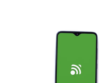 Lod, Israel - July 16,2023: Unified Remote app launch screen on smartphone on white background. Top view flat lay with copy space.
