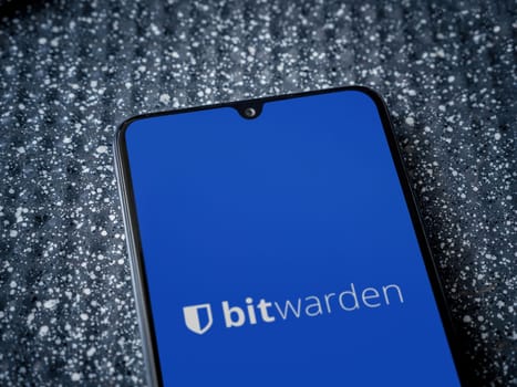 Lod, Israel - July 16,2023: Bitwarden Password Manager app launch screen on smartphone on metallic background. Close up top view flat lay.