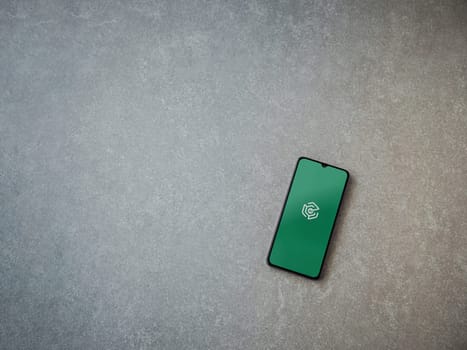 Lod, Israel - July 16,2023: Adam Ai app launch screen on smartphone on ceramic stone background. Top view flat lay with copy space.