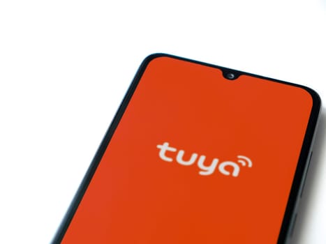 Lod, Israel - July 16,2023: Tuya Smart app launch screen on smartphone on white background. Top view flat lay with copy space.