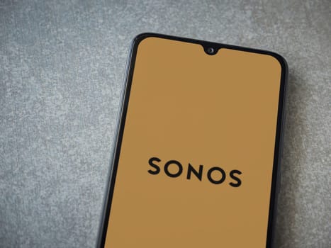 Lod, Israel - July 16,2023: Sonos app launch screen on smartphone on ceramic stone background. Top view flat lay with copy space.