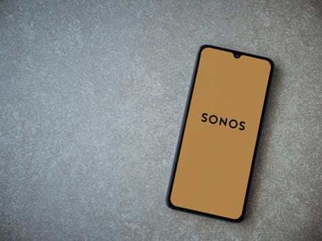 Lod, Israel - July 16,2023: Sonos app launch screen on smartphone on ceramic stone background. Top view flat lay with copy space.