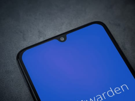 Lod, Israel - July 16,2023: Bitwarden Password Manager app launch screen on smartphone on dark marble stone background. Top view flat lay with copy space.