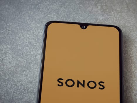 Lod, Israel - July 16,2023: Sonos app launch screen on smartphone on ceramic stone background. Top view flat lay with copy space.