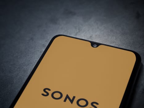 Lod, Israel - July 16,2023: Sonos app launch screen on smartphone on dark marble stone background. Top view flat lay with copy space.