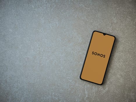 Lod, Israel - July 16,2023: Sonos app launch screen on smartphone on ceramic stone background. Top view flat lay with copy space.