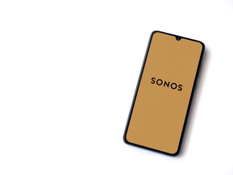 Lod, Israel - July 16,2023: Sonos app launch screen on smartphone on white background. Top view flat lay with copy space.