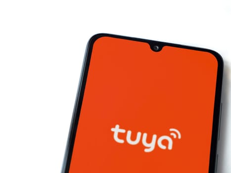 Lod, Israel - July 16,2023: Tuya Smart app launch screen on smartphone on white background. Top view flat lay with copy space.