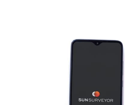 Lod, Israel - July 16,2023: Sun Surveyor app launch screen on smartphone on white background. Top view flat lay with copy space.