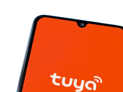 Lod, Israel - July 16,2023: Tuya Smart app launch screen on smartphone on white background. Top view flat lay with copy space.