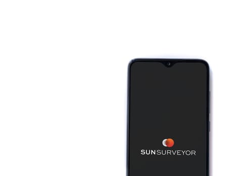 Lod, Israel - July 16,2023: Sun Surveyor app launch screen on smartphone on white background. Top view flat lay with copy space.