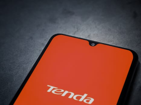 Lod, Israel - July 16,2023: Tenda Wifi app launch screen on smartphone on dark marble stone background. Top view flat lay with copy space.
