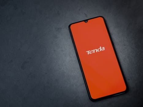 Lod, Israel - July 16,2023: Tenda Wifi app launch screen on smartphone on dark marble stone background. Top view flat lay with copy space.