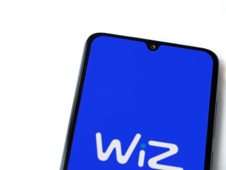 Lod, Israel - July 16,2023: WIZ app launch screen on smartphone on white background. Top view flat lay with copy space.