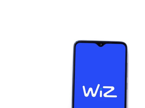 Lod, Israel - July 16,2023: WIZ app launch screen on smartphone on white background. Top view flat lay with copy space.