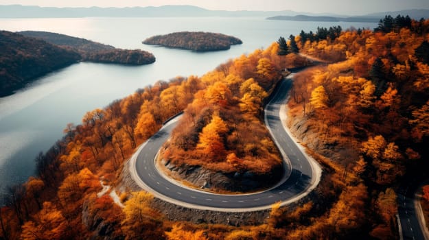 Aerial view over winding road on a mountain top with colored autumn trees.Curvy road in atumn forest on a mountains. AI generated