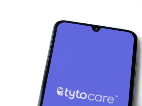 Lod, Israel - July 16,2023: TytoCare app launch screen on smartphone on white background. Top view flat lay with copy space.