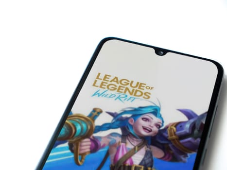Lod, Israel - July 16,2023: League of Legends - Wild Rift app launch screen on smartphone on white background. Top view flat lay with copy space.